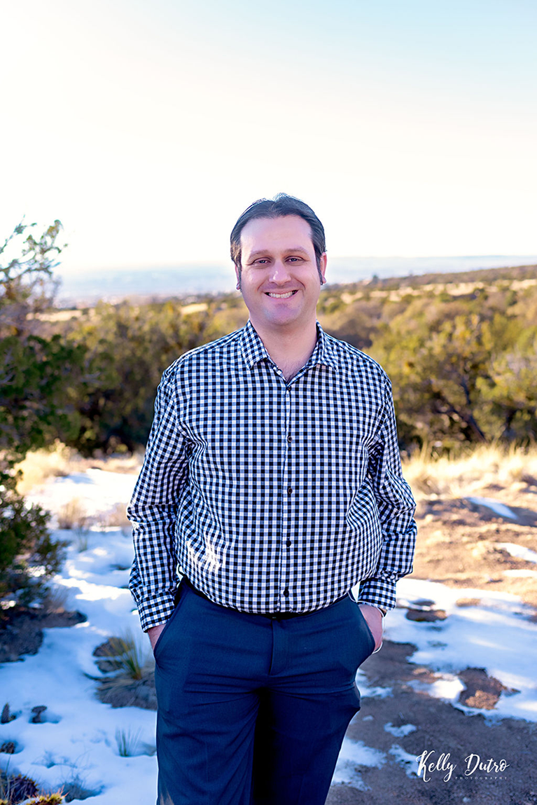 The author, smiling, with the Sandia mountains in the background.