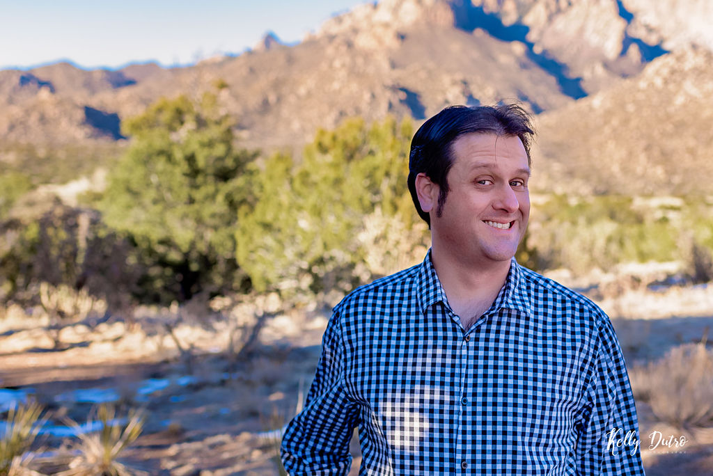 The author, smiling, with the Sandia mountains in the background.